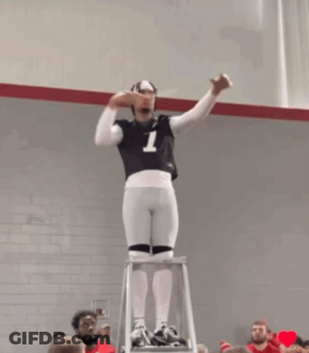 A Man Standing On A Ladder With The Number 7 On His Jersey GIF