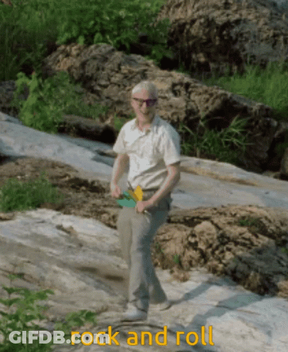 A Man Standing On A Rock With The Words Rock And Roll Written Below Him GIF