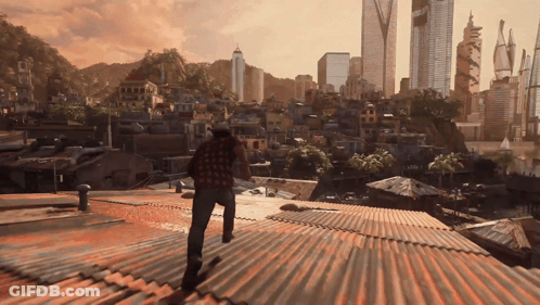 A Man Standing On A Rooftop Looking Out Over A City GIF