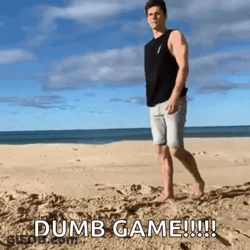 A Man Standing On A Sandy Beach With The Words Dumb Game !!! GIF