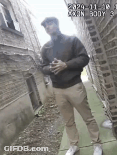 A Man Standing On A Sidewalk With The Date 2024-11-101 GIF