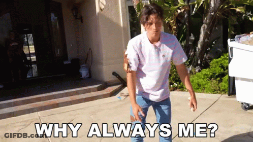 A Man Standing On A Sidewalk With The Words " Why Always Me " Written On It GIF