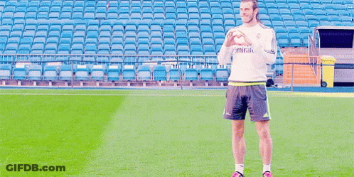 A Man Standing On A Soccer Field Wearing A Shirt That Says Emirates On It GIF