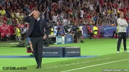 A Man Standing On A Soccer Field With His Hands On His Head . GIF