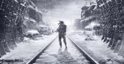 A Man Standing On A Train Track In The Snow GIF