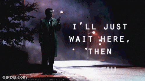A Man Standing On The Side Of A Road With The Words " I 'Ll Just Wait Here Then " On The Bottom GIF