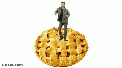 A Man Standing On Top Of A Large Pie GIF