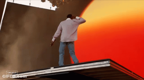 A Man Standing On Top Of A Roof With The Word Cancel On The Bottom Right GIF