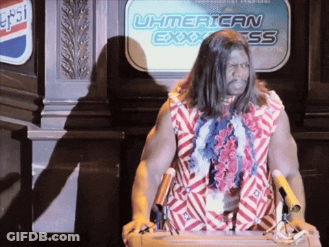 A Man Stands At A Podium In Front Of A Sign That Says Uh American Express GIF
