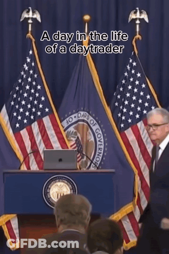 A Man Stands At A Podium In Front Of An American Flag With The Words A Day In The Life Of A Daytrader Above Him GIF