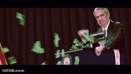 A Man Stands At A Podium While Money Falls From The Sky GIF