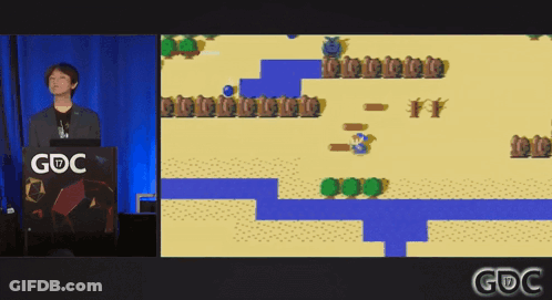 A Man Stands At A Podium With A Gdc Logo On It GIF