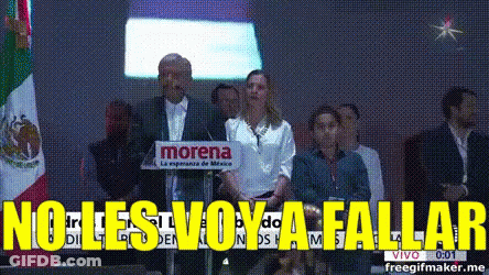 A Man Stands At A Podium With A Morena Sign Behind Him GIF