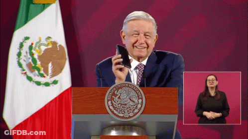A Man Stands At A Podium With A Seal That Says Mexicanos Unidos Mexicanos GIF