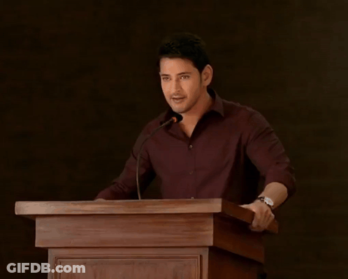 A Man Stands At A Podium With The Words " I 'M Not Done Yet " Above Him GIF