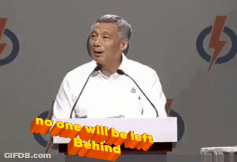 A Man Stands At A Podium With The Words No One Will Be Left Behind GIF