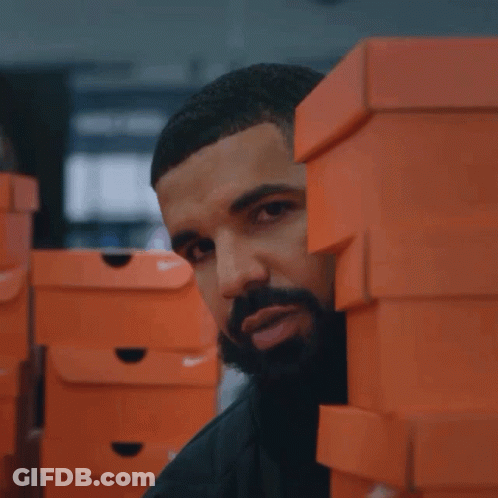 A Man Stands Behind A Stack Of Nike Boxes GIF