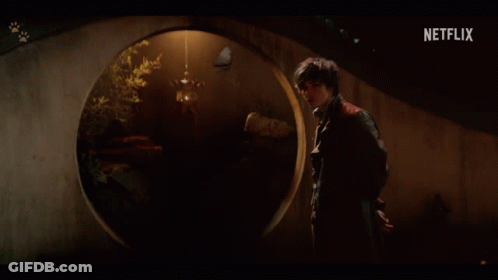 A Man Stands In A Dark Room With A Netflix Logo On The Bottom GIF