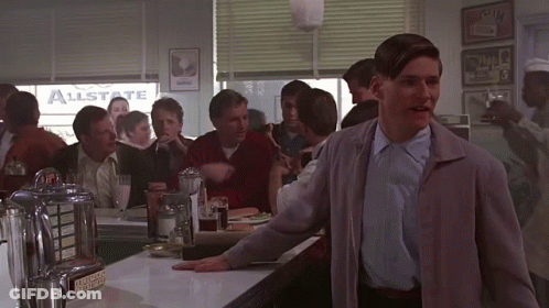 A Man Stands In A Diner With A Sign That Says Allstate GIF