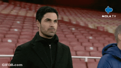 A Man Stands In An Empty Stadium With Mola Tv Written On The Bottom Right GIF