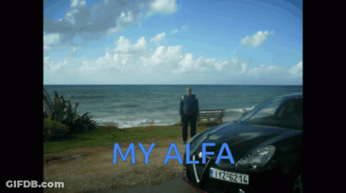 A Man Stands In Front Of A Black Car That Says My Alfa On The Side GIF