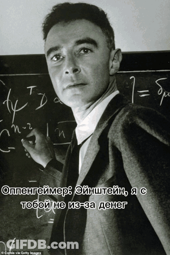 A Man Stands In Front Of A Blackboard With Numbers Written On It GIF
