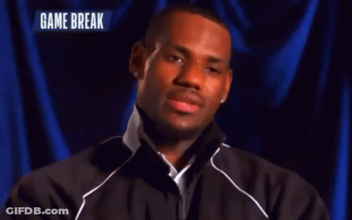 A Man Stands In Front Of A Blue Curtain With The Words Game Break On The Bottom GIF
