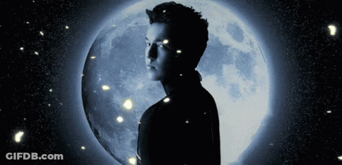 A Man Stands In Front Of A Blue Full Moon GIF