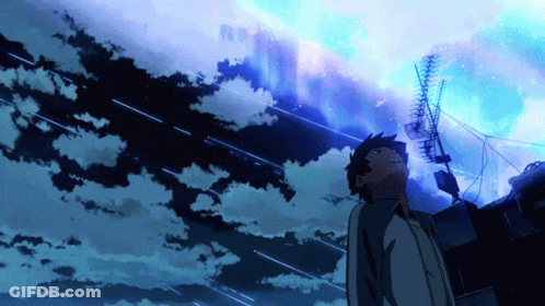 A Man Stands In Front Of A Blue Sky With A Lot Of Clouds GIF