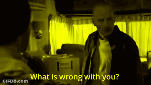 A Man Stands In Front Of A Box That Says Fragile GIF