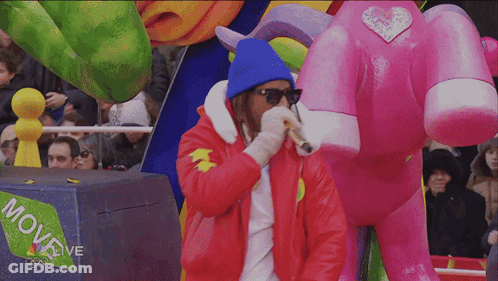 A Man Stands In Front Of A Box That Says Move Live On It GIF