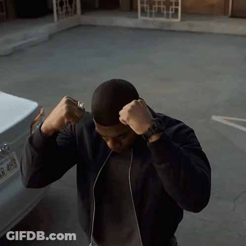A Man Stands In Front Of A Car With A License Plate That Says R 4H9 GIF