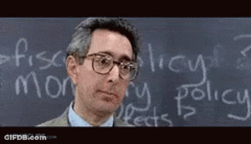 A Man Stands In Front Of A Chalkboard With The Word Policy Written On It GIF
