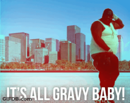 A Man Stands In Front Of A City Skyline With The Words It 'S All Gravy Baby Below Him GIF
