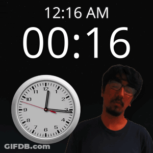 A Man Stands In Front Of A Clock That Reads 12:16 GIF