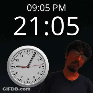 A Man Stands In Front Of A Clock That Reads 20:05 GIF