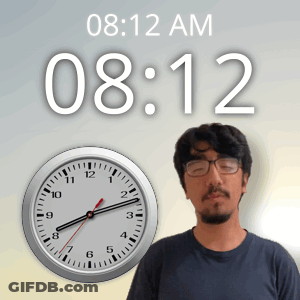 A Man Stands In Front Of A Clock That Says 08:12 GIF