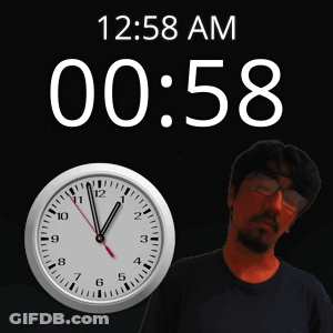 A Man Stands In Front Of A Clock That Says 12:58 Am On It GIF