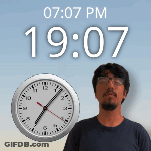 A Man Stands In Front Of A Clock That Says 19:07 Pm GIF