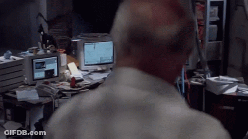 A Man Stands In Front Of A Computer Monitor That Says ' I 'M Sorry ' On It GIF