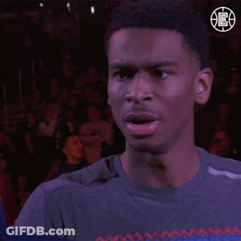 A Man Stands In Front Of A Crowd Wearing A Nba Logo GIF