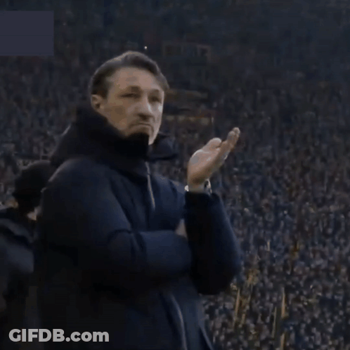 A Man Stands In Front Of A Crowd With A Sign That Says ' Allianz ' GIF