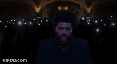 A Man Stands In Front Of A Crowd With A Sticker On His Forehead That Says I Love You GIF