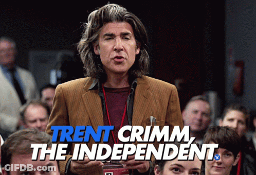 A Man Stands In Front Of A Crowd With The Words Trent Crimm The Independent Written Below Him GIF