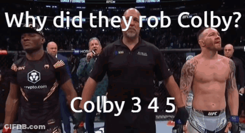 A Man Stands In Front Of A Crowd With The Words Why Did They Rob Colby On The Bottom GIF