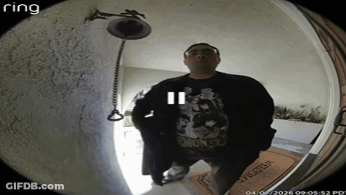 A Man Stands In Front Of A Door With A Welcome Mat GIF