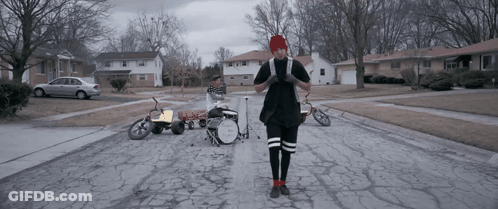 A Man Stands In Front Of A Drum Set That Says Twenty One Pilots On It GIF