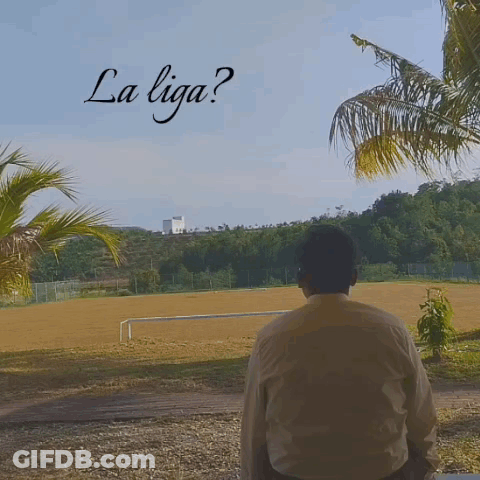 A Man Stands In Front Of A Field With The Words La Liga Written On The Top GIF
