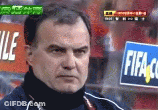 A Man Stands In Front Of A Fifa Sign GIF