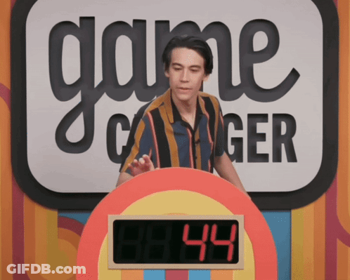 A Man Stands In Front Of A Game Called Game Changer GIF